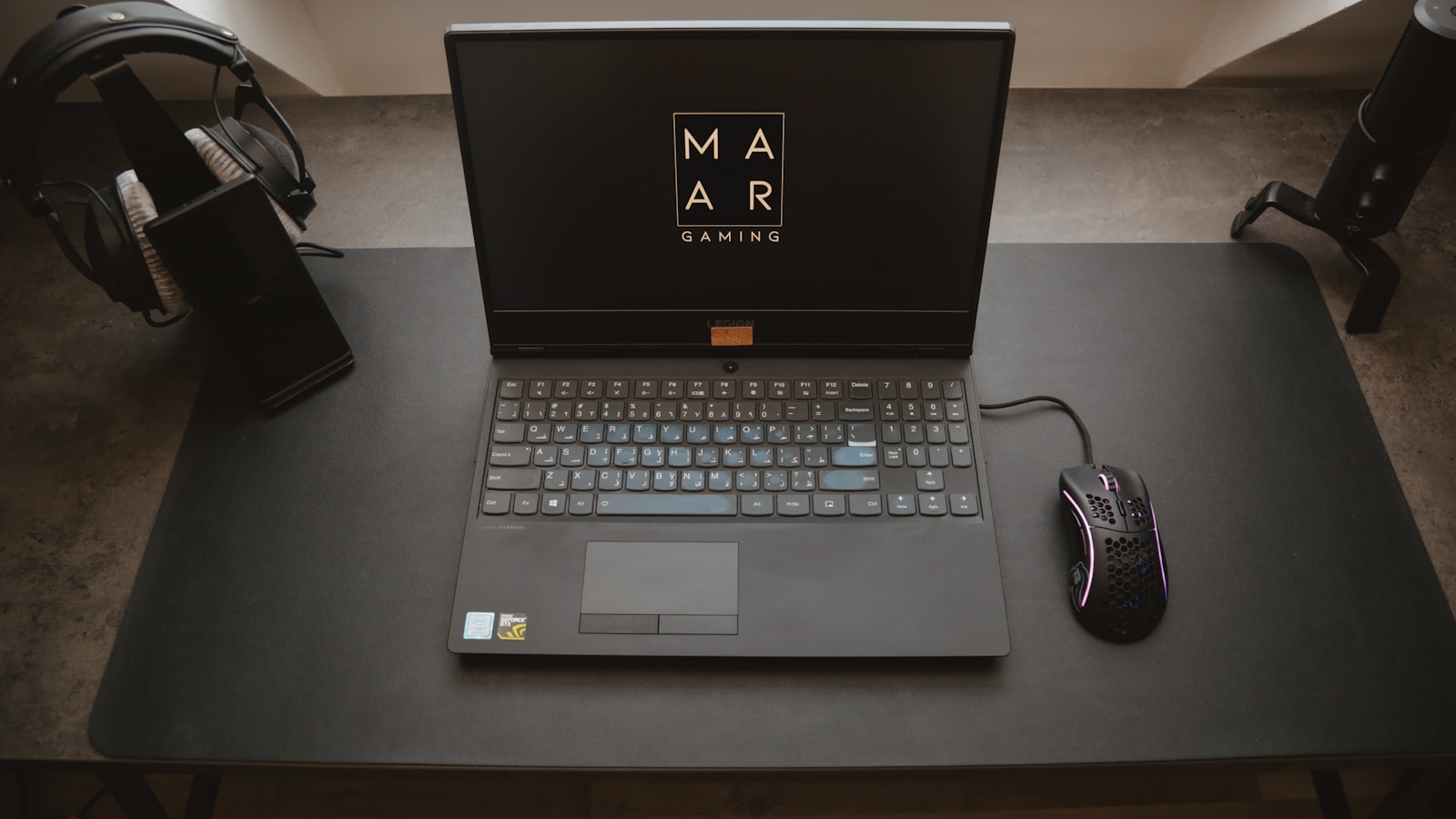 black asus laptop computer on black table